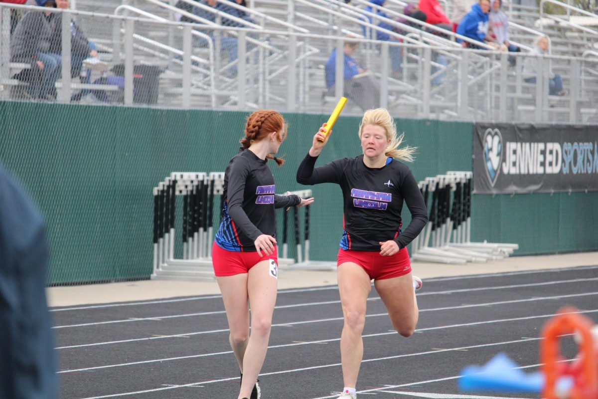 Liberty Bates ('24) handing off the baton to Allison Lee ('27) during last year's season.