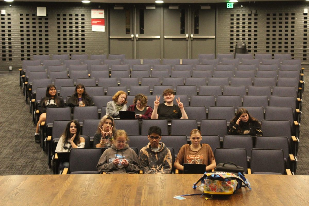 Tech Theater class sitting in auditorium for script reading.