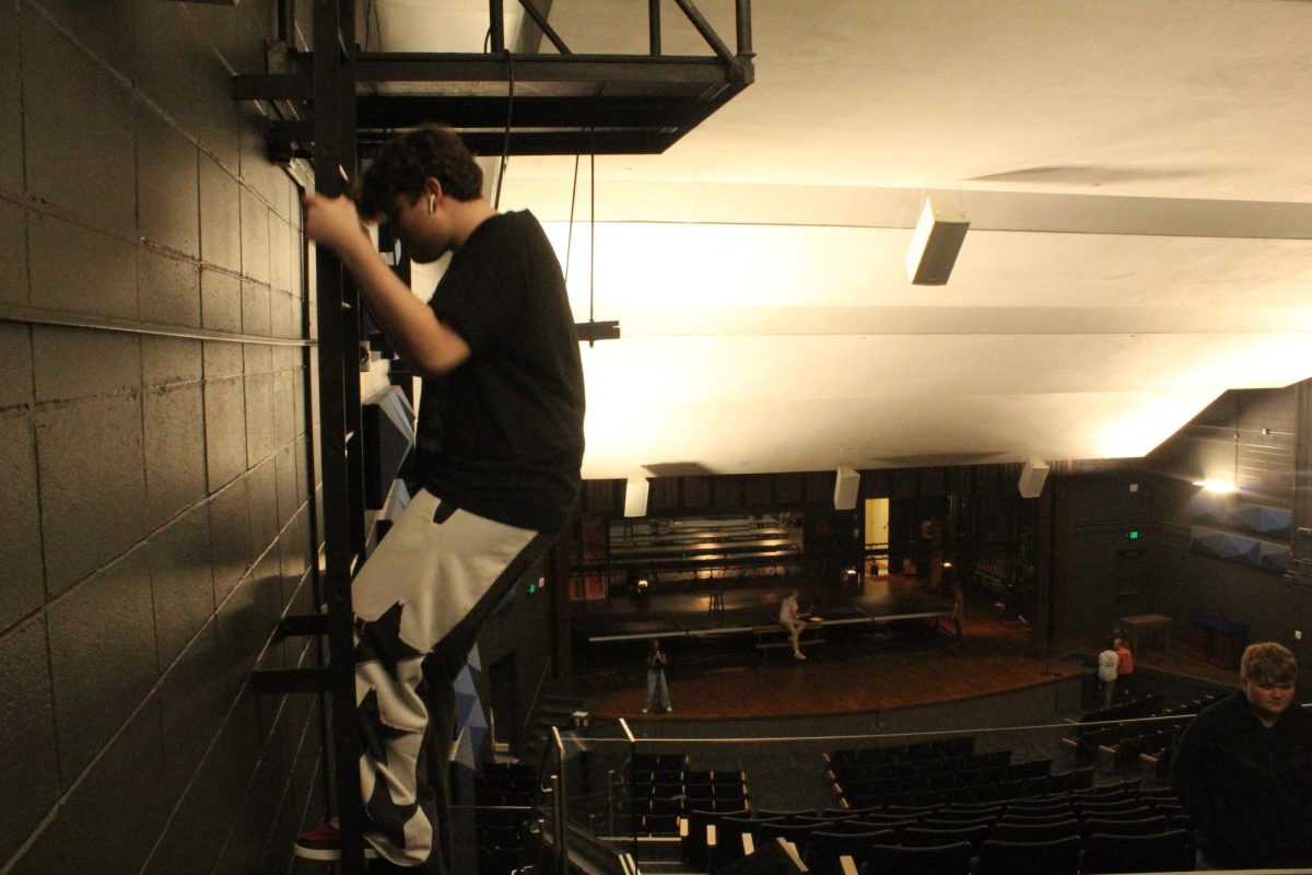 Junior Hayden Morrow climbing down from one of the spotlight towers