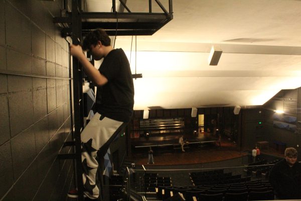 Junior Hayden Morrow climbing down from one of the spotlight towers